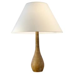 a table lamp with a white shade on it's base and a wooden base