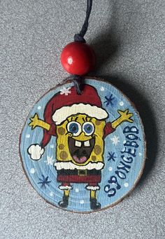 a wooden ornament with an image of a cartoon character wearing a santa hat