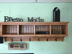 there is a shelf with some books on it and other items hanging from the wall