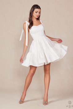 Part of our Informals collection, this beauty brings romantic flair to your bridal festivities. Crafted from structured fabric for a polished look and defined shape, the gentle sweetheart neckline highlights your shoulders and décolletage. A tiered skirt adds graceful movement and volume, creating a silhouette that flatters every figure. Perfect for your engagement photoshoot, rehearsal dinner, or wedding reception. Available for special order in additional sizes and colors. Contact us for avail Corset Ball Gowns, Short A Line Dress, Off Shoulder Ball Gown, Bow Straps, Corset Boning, A Line Cocktail Dress, Rehearsal Dinner Dresses, Boned Bodice, Ribbon Dress