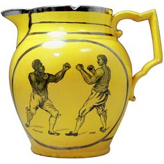 a yellow vase with two men boxing on it