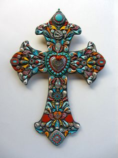 a colorful cross with an intricate design on the front and back side, is displayed against a white background