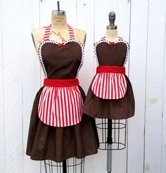 two mannequins dressed in aprons on top of each other with red and white stripes