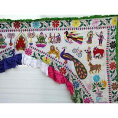 the colorful wall hanging has many different designs on it