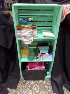 a green shelf filled with lots of items