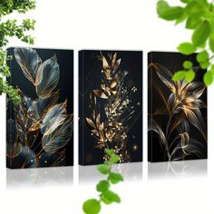 three canvases with gold leaves on them and one is in front of the other