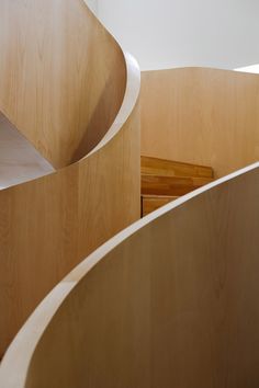 a wooden spiral staircase in an office building