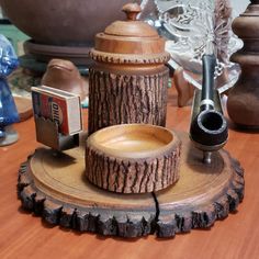 a wooden tray with various items on top of it, including a coffee pot and grinder