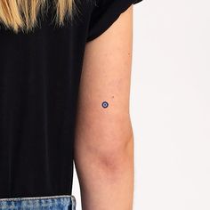 a woman's arm with a small dot on the left side of her arm