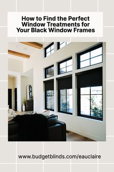 a living room with black windows and white tile on the walls, in front of a couch