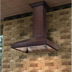 an outdoor range hood mounted on the side of a brick wall