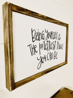 a sign hanging on the wall that says being yourself is the prettiest thing you can be