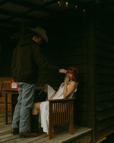 a man standing next to a woman on a porch