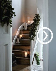 the stairs are decorated with candles and greenery