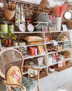 a room filled with lots of different types of items on shelves next to a brick wall