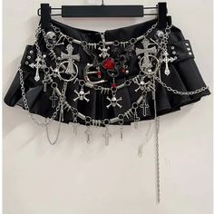 🌟 Edgy and Divine: Chained Cross Mini Skirt 👗 Unleash Your Inner Rebel: Make a bold statement with the Chained Cross Mini Skirt, meticulously crafted for those who dare to challenge conventions and embrace their unique style. This mini skirt is a must-have for anyone looking to add a touch of edgy flair to their wardrobe. ✨ Superior Comfort and Striking Design: Meticulously crafted for top-notch quality, this mini skirt offers exceptional comfort with a striking and daring design. Whether you're hitting the club, attending a concert, or simply want to stand out from the crowd, the Chained Cross Mini Skirt is the perfect choice for making a statement. ⛓️ Adorned with Cross Chains: Featuring eye-catching cross chain embellishments, this mini skirt exudes a sense of mystique and rebellion. Alternative Fashion Accessories, Y2k Clothes Design, Black Concert Top, Alternative Club Outfit, Chains Outfit, Black Fashion Aesthetic, Skirt With Chains, Cross Clothes, Diy Mini Skirt