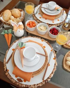 the table is set with dishes, cups and plates for breakfast or brunch