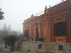 an old building is shown in the fog