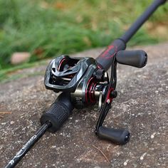 a close up of a fishing reel on a rock