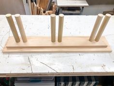 a wooden sculpture on top of a table in a room filled with woodworking supplies