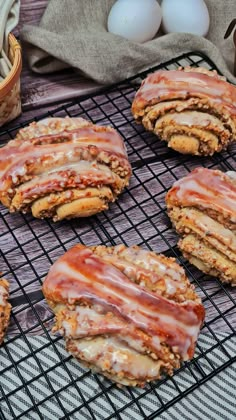 several cookies with icing sitting on a cooling rack