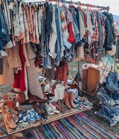 clothes and shoes are on display at an outdoor market