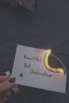 someone holding up a piece of paper with the words beautiful, but destructive written on it