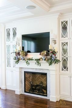 the fireplace is decorated with flowers and candles