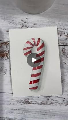 a candy cane on top of a piece of paper