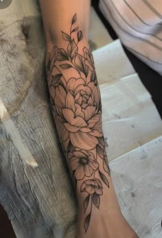 a person with a flower tattoo on their arm