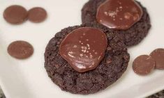 two chocolate cookies with peanut butter on top