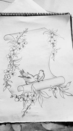 a drawing of two birds sitting on top of a piece of paper with flowers around it