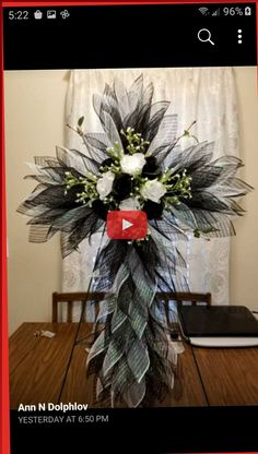 a vase filled with flowers on top of a wooden table