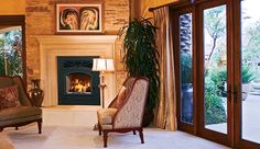 a living room filled with furniture and a fire place in the middle of a room