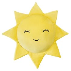 a yellow sun pillow with eyes closed