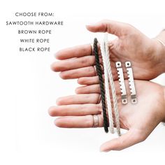 two hands holding several different types of rings and bracelets with the words choose from, sawtooth hardware, brown rope, white rope, black rope, and black rope