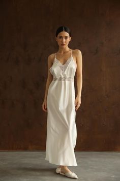 This long white Slip Dress made of soft pure mulberry silk. A V-neckline with lace, open back with adjustable spaghetti straps, meet a bias cut to fall beautifully against the body, inspiring a feminine silhouette. Effortless for both day and night, for romantic evening or as a bridal getting ready dress.   Model is 168 cm, 84/64/89 wears size XS Total length 135 cm from the shoulder  Off white color Luxury Sleeveless Feminine Slip Dress, Luxury Lined Bodice Slip Dress For Women, Luxury Romantic Maxi-length Slip Dress, Luxury Elegant Slip Dress With Lace Bodice, Luxury Fitted Slip Dress For Beach, Luxury Maxi Length Slip Dress With Lace Trim, Luxury Chic Slip Dress With Delicate Lace, Luxury Silk Slip Dress With Delicate Lace, Luxury Long Slip Dress