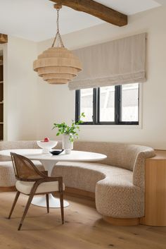 a white table and some chairs in a room