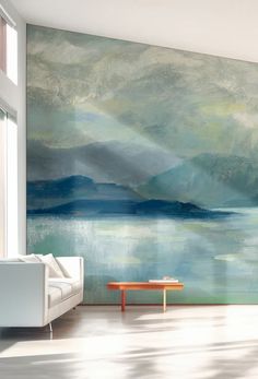 a living room with a large painting on the wall next to a couch and coffee table