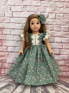 a doll with long hair wearing a green dress