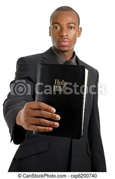 a man in a suit holding a bible