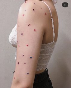 the back of a woman's shoulder with small sprinkles on it