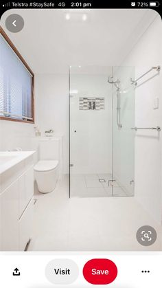 a white bathroom with a glass shower door