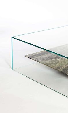 a glass coffee table with a marble top and metal base, on a white background