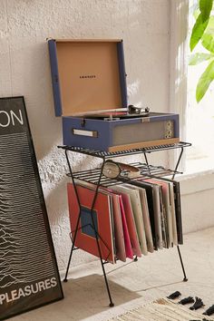 a record player sitting on top of a metal rack