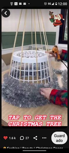 someone is decorating a birdcage with tinsel and fake fur on the floor