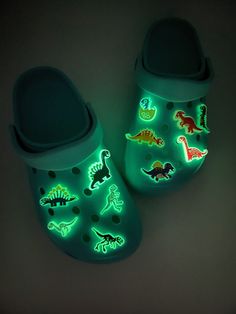 Dinosaur Glow in the dark charms for all dinosaur lovers. Charms must be exposed to light to absorb energy to enable it glow. Place under flourescent light for a few second and watch your charms glow in the dark. Personalize you Crocs or Croc-like shoes and silicone bracelets with these stylish shoe charms. How to order. List the alphabet at the top of each charm in the personalization tab. Each charm is *Individually sold. Shoes are not included! Size: Varies between each charm. Measures about Dinosaur Merch, Jibits For Crocs, Croc Charms Ideas, Glow In The Dark Clothes, Dinosaur Accessories, Dinosaur Things, Glow In The Dark Shoes, Dinosaur Clothes, Dinosaur Stuff