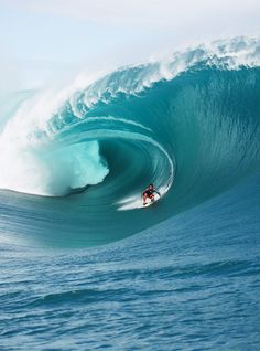 a man riding a wave on top of a surfboard