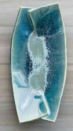 a blue and white plate sitting on top of a wooden table