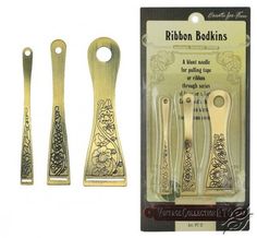 three gold colored kitchen utensils in packaging